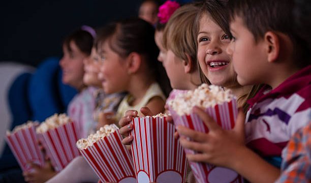 kids at the cinema eating popcorn